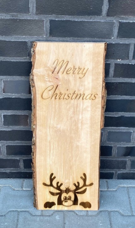 Eine Weihnachtsholzbohle mit einem Weihnachtsmann und einen Schriftzug "Frohe Weihnachten".